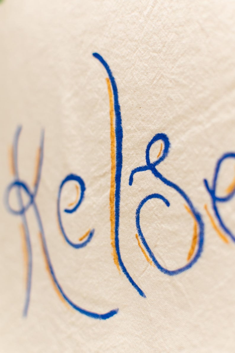 Close-up of hand-lettered name in blue script