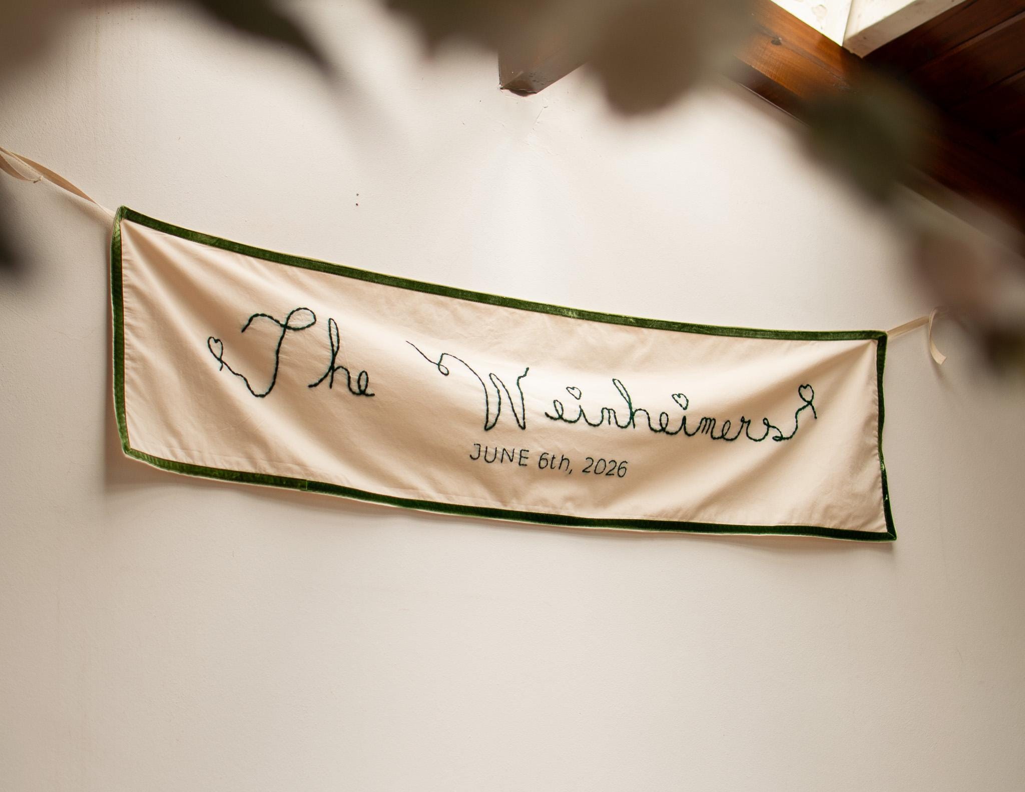 Personalized banner with embroidered text on a plain background